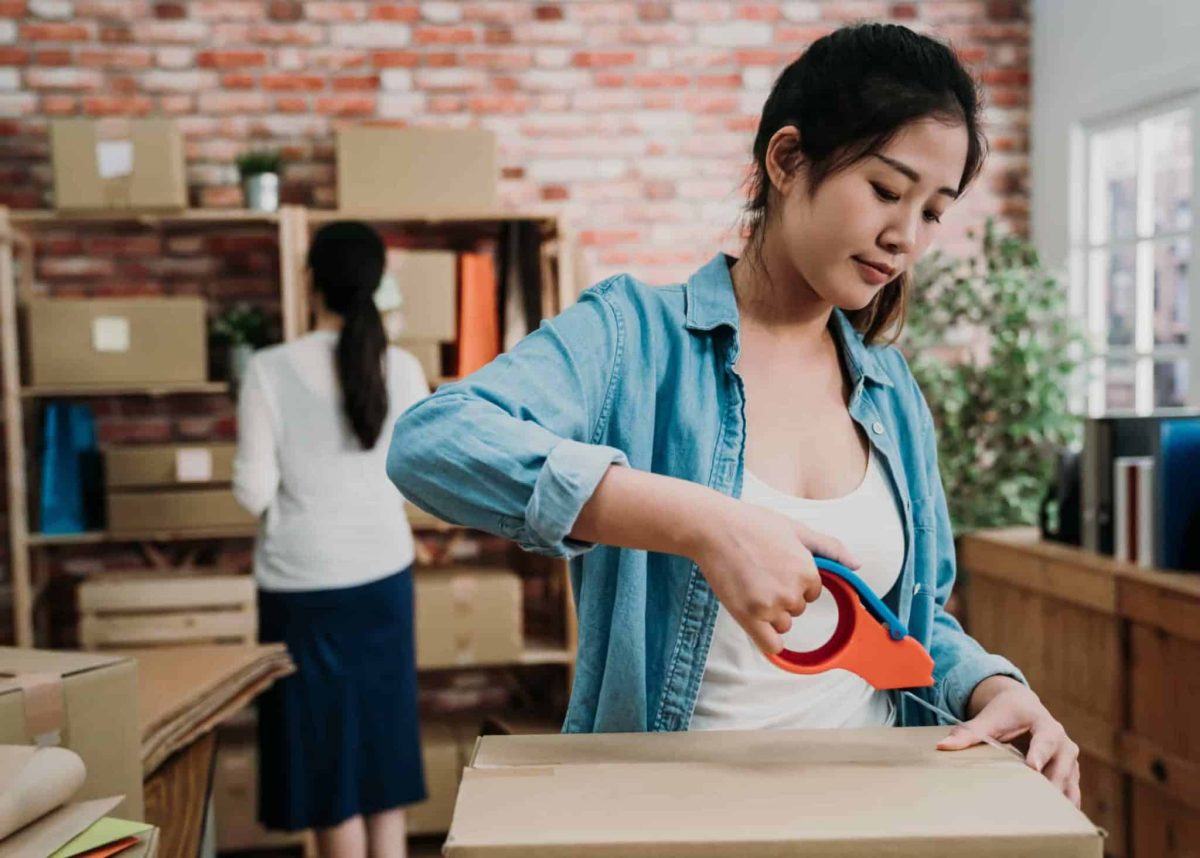 Office worker packs box for storage